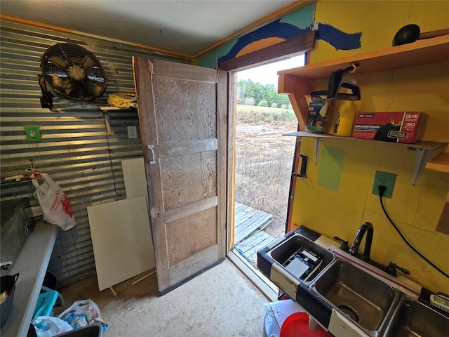 doorway with sink and concrete floors