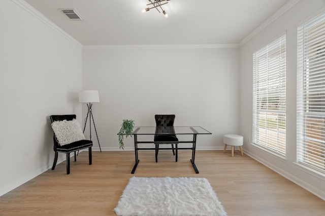 sitting room featuring plenty of natural light, an inviting chandelier, ornamental molding, and light hardwood / wood-style flooring