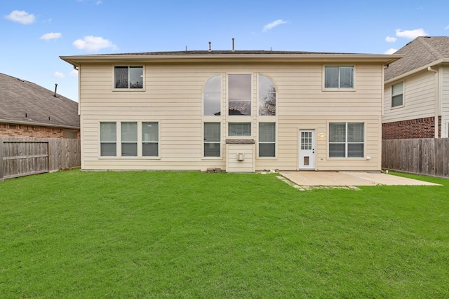 back of house with a lawn and a patio area