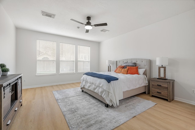 bedroom with light hardwood / wood-style flooring and ceiling fan