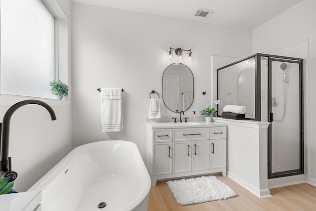 bathroom featuring hardwood / wood-style floors, vanity, plenty of natural light, and independent shower and bath