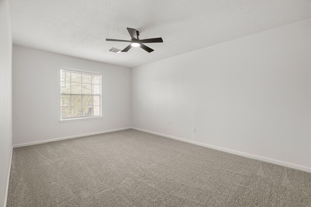 spare room with carpet floors and ceiling fan