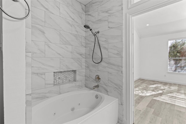 bathroom with tiled shower / bath combo and wood-type flooring