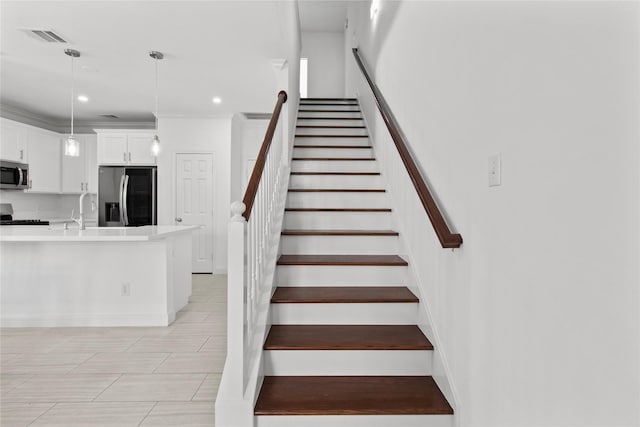 stairway with ornamental molding and sink