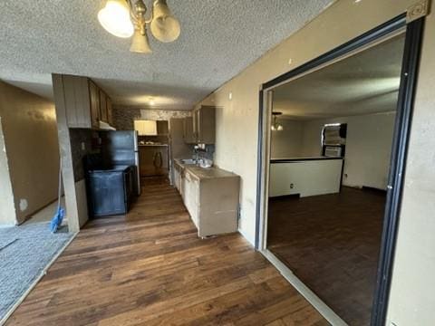 kitchen featuring a textured ceiling and dark wood-type flooring