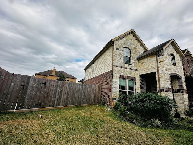 view of property exterior with a yard