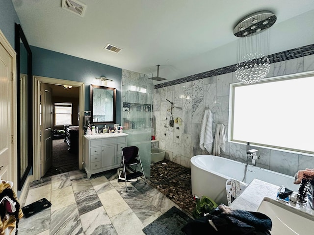 bathroom featuring plus walk in shower, vanity, and a notable chandelier