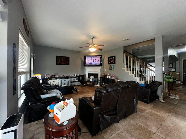 tiled living room featuring ceiling fan