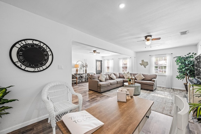 living room with ceiling fan and hardwood / wood-style flooring