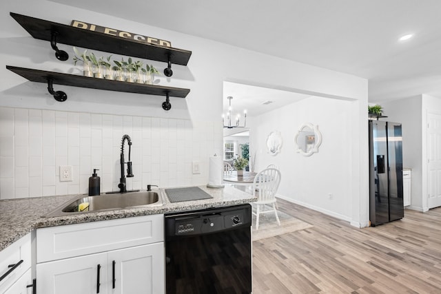 kitchen featuring dishwasher, sink, stainless steel refrigerator with ice dispenser, backsplash, and white cabinets