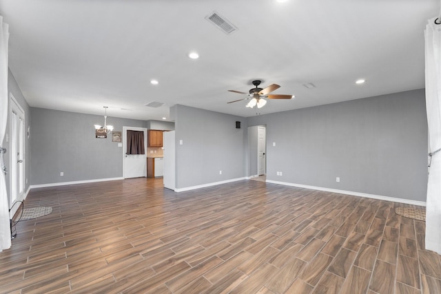 unfurnished living room with ceiling fan with notable chandelier