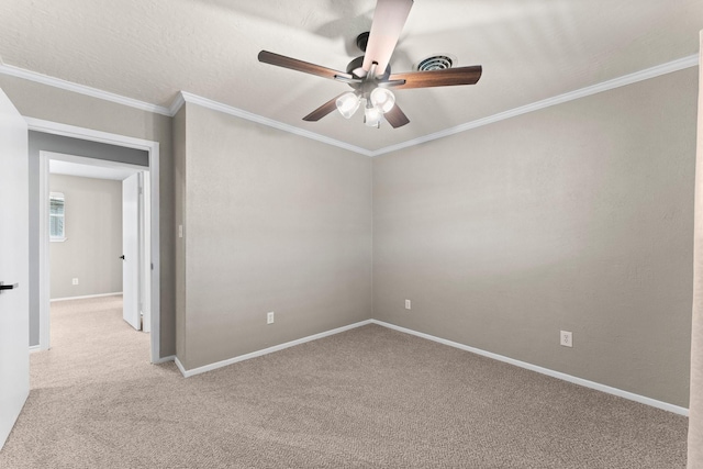 carpeted empty room featuring ceiling fan and ornamental molding