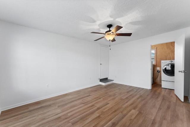 unfurnished room with ceiling fan, washer / clothes dryer, light hardwood / wood-style flooring, and a textured ceiling