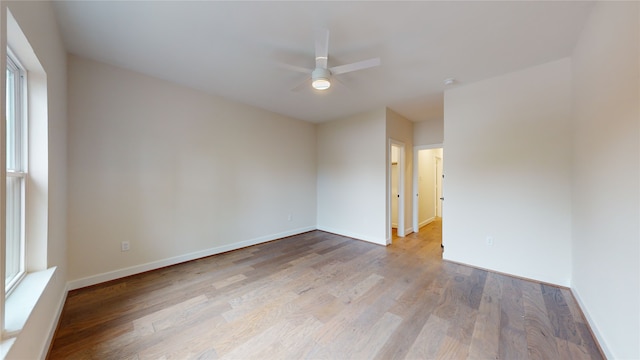 unfurnished room featuring light hardwood / wood-style flooring and ceiling fan