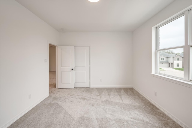 carpeted empty room with a healthy amount of sunlight