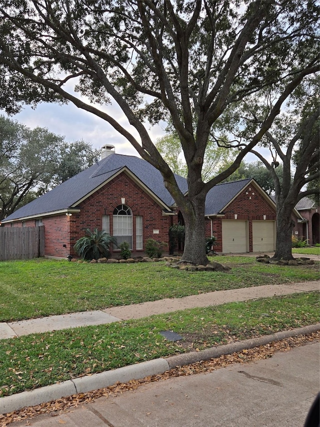 ranch-style home with a garage and a front lawn