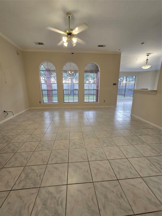 tiled spare room with crown molding and ceiling fan