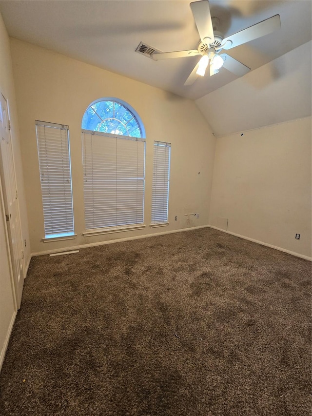 empty room with carpet, ceiling fan, and vaulted ceiling