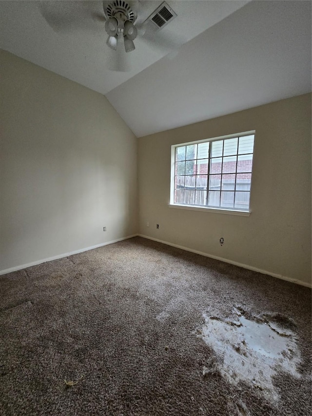 spare room featuring carpet flooring, ceiling fan, and vaulted ceiling