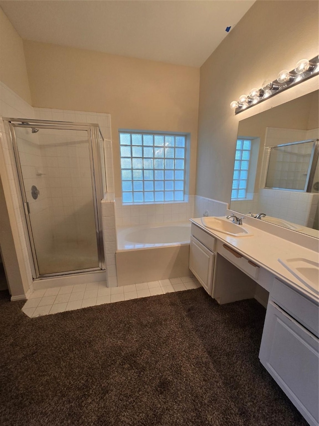 bathroom featuring vanity and separate shower and tub