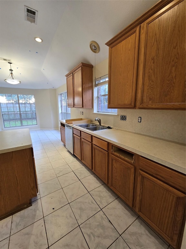 kitchen with stainless steel dishwasher, sink, light tile patterned floors, decorative light fixtures, and lofted ceiling