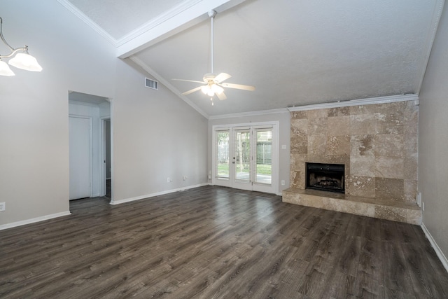 unfurnished living room with ceiling fan, dark hardwood / wood-style floors, crown molding, lofted ceiling, and a fireplace