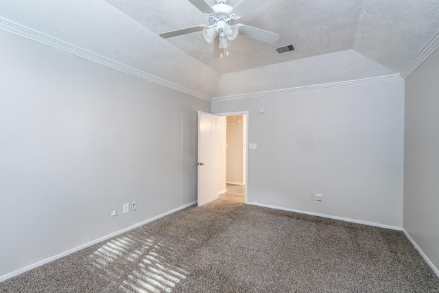 carpeted spare room with ornamental molding, a textured ceiling, a tray ceiling, and vaulted ceiling