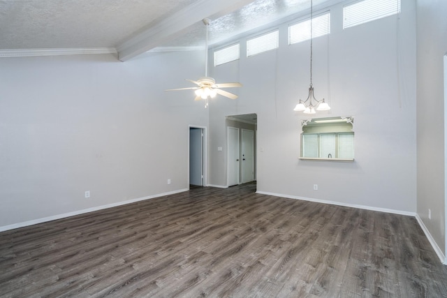 unfurnished living room with a towering ceiling, dark hardwood / wood-style flooring, a textured ceiling, ceiling fan with notable chandelier, and beamed ceiling