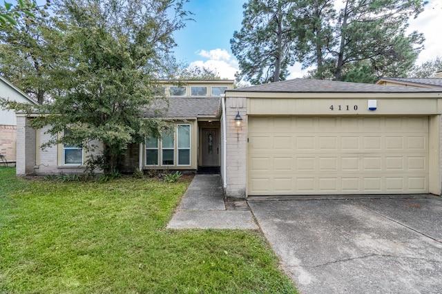 view of front of home with a garage and a front lawn