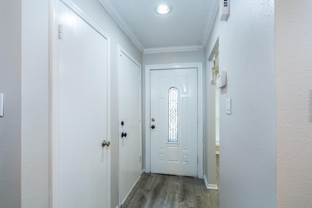 entryway featuring ornamental molding and dark wood-type flooring