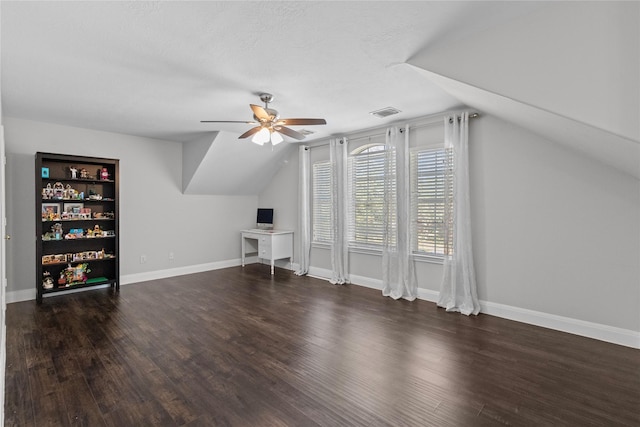 bonus room with ceiling fan, dark hardwood / wood-style flooring, and vaulted ceiling