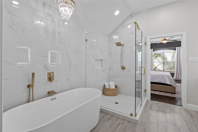 bathroom with plus walk in shower, a chandelier, tile walls, and lofted ceiling