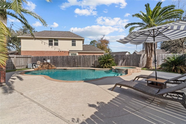 view of swimming pool featuring a patio area and an in ground hot tub