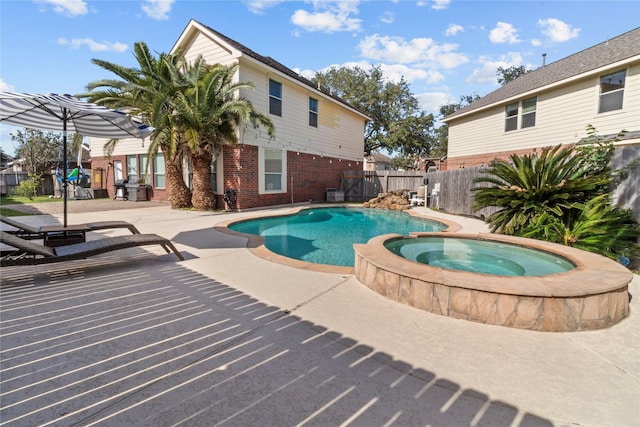 view of swimming pool featuring a patio area and an in ground hot tub