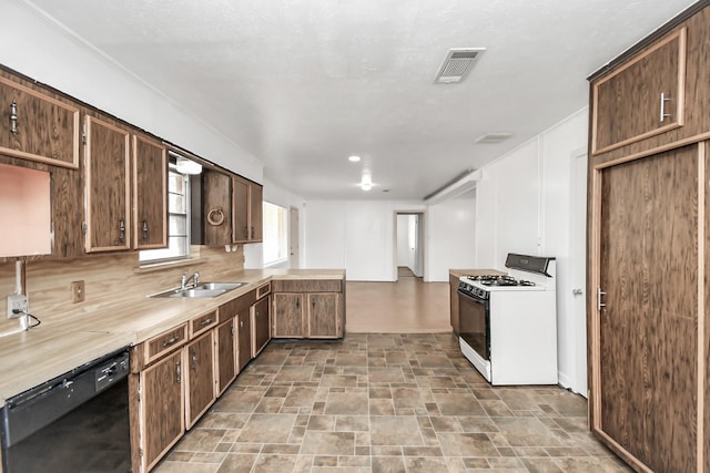 kitchen with dishwasher, sink, white gas range oven, tasteful backsplash, and dark brown cabinets