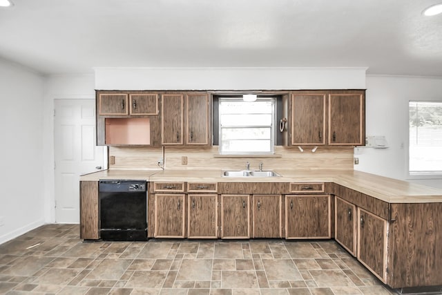 kitchen featuring backsplash, a wealth of natural light, sink, and black dishwasher