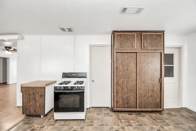 kitchen with ceiling fan, dark brown cabinets, and white gas range oven