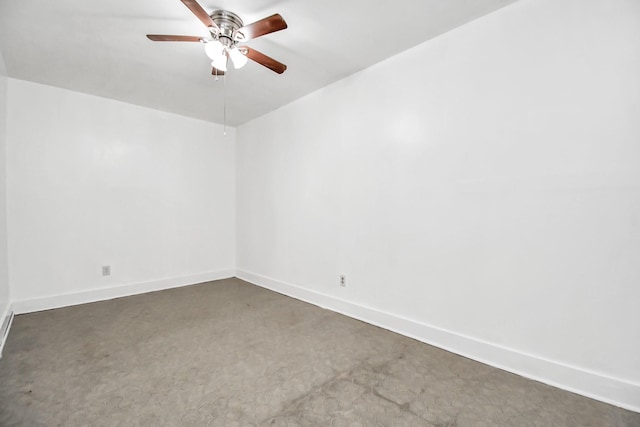 empty room with ceiling fan and dark colored carpet