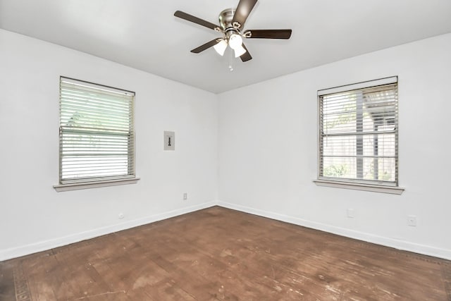 unfurnished room with ceiling fan and dark wood-type flooring