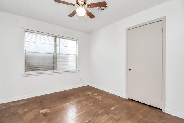 unfurnished room featuring ceiling fan and dark wood-type flooring