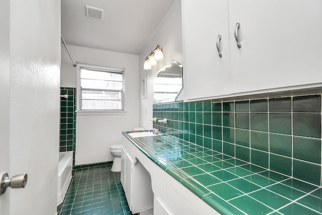 full bathroom with tile patterned floors, vanity, toilet, and  shower combination