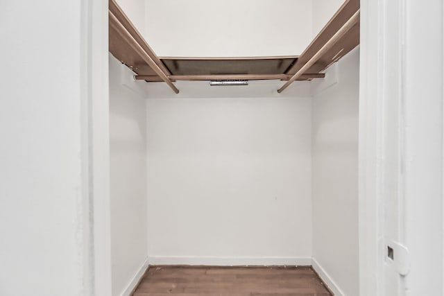 spacious closet featuring dark hardwood / wood-style flooring