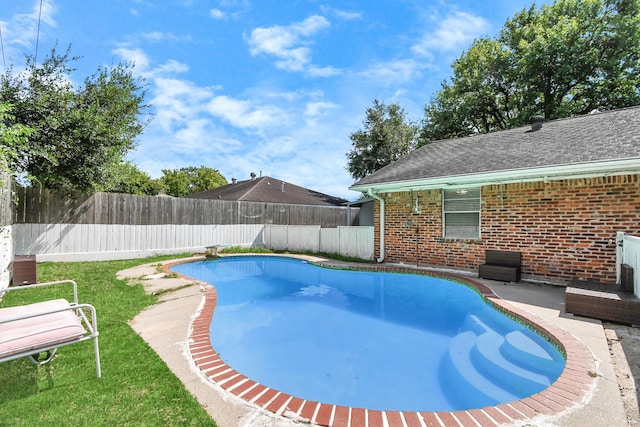 view of swimming pool with a lawn and a patio area