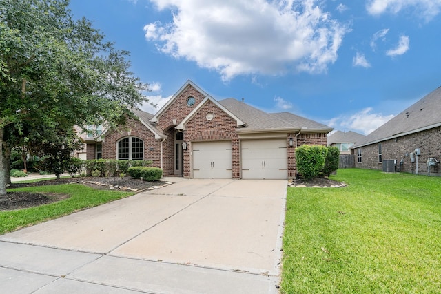 front facade with a front lawn, a garage, and cooling unit