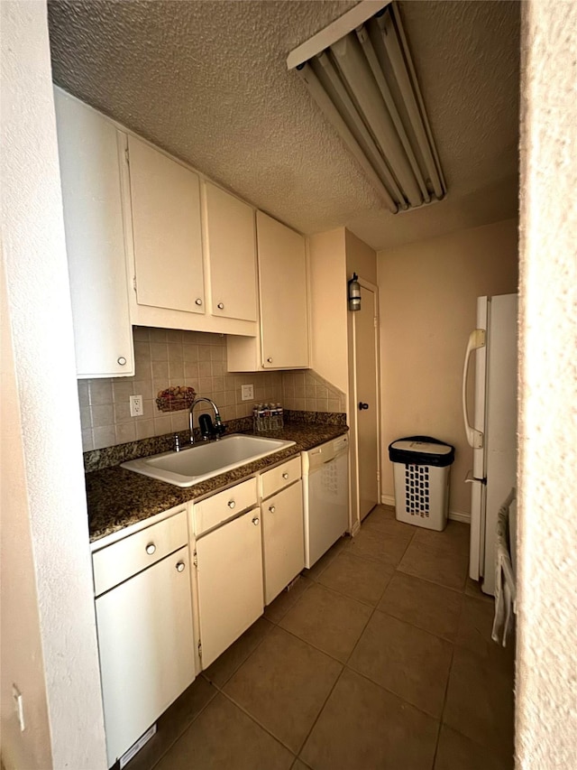 kitchen with white cabinetry, sink, white appliances, and backsplash