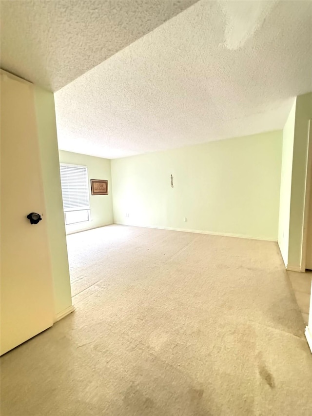 carpeted spare room featuring a textured ceiling