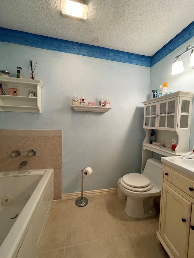 bathroom with a washtub, vanity, a textured ceiling, tile patterned flooring, and toilet