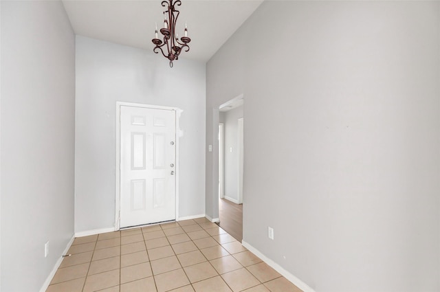 foyer featuring light tile patterned floors and a notable chandelier