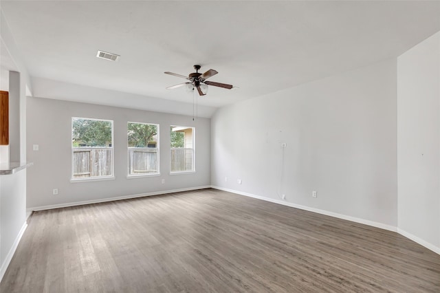 empty room featuring ceiling fan, dark hardwood / wood-style floors, and lofted ceiling