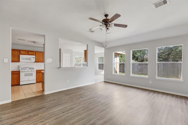 unfurnished living room featuring light hardwood / wood-style flooring and ceiling fan